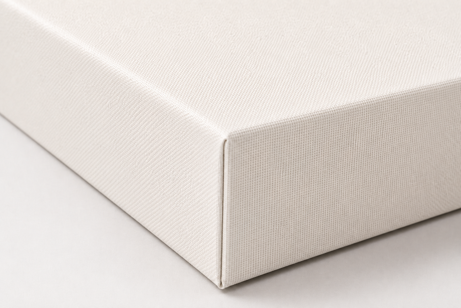 Close-up of a blank gallery-wrapped canvas corner showing its texture, folded edge, and depth
